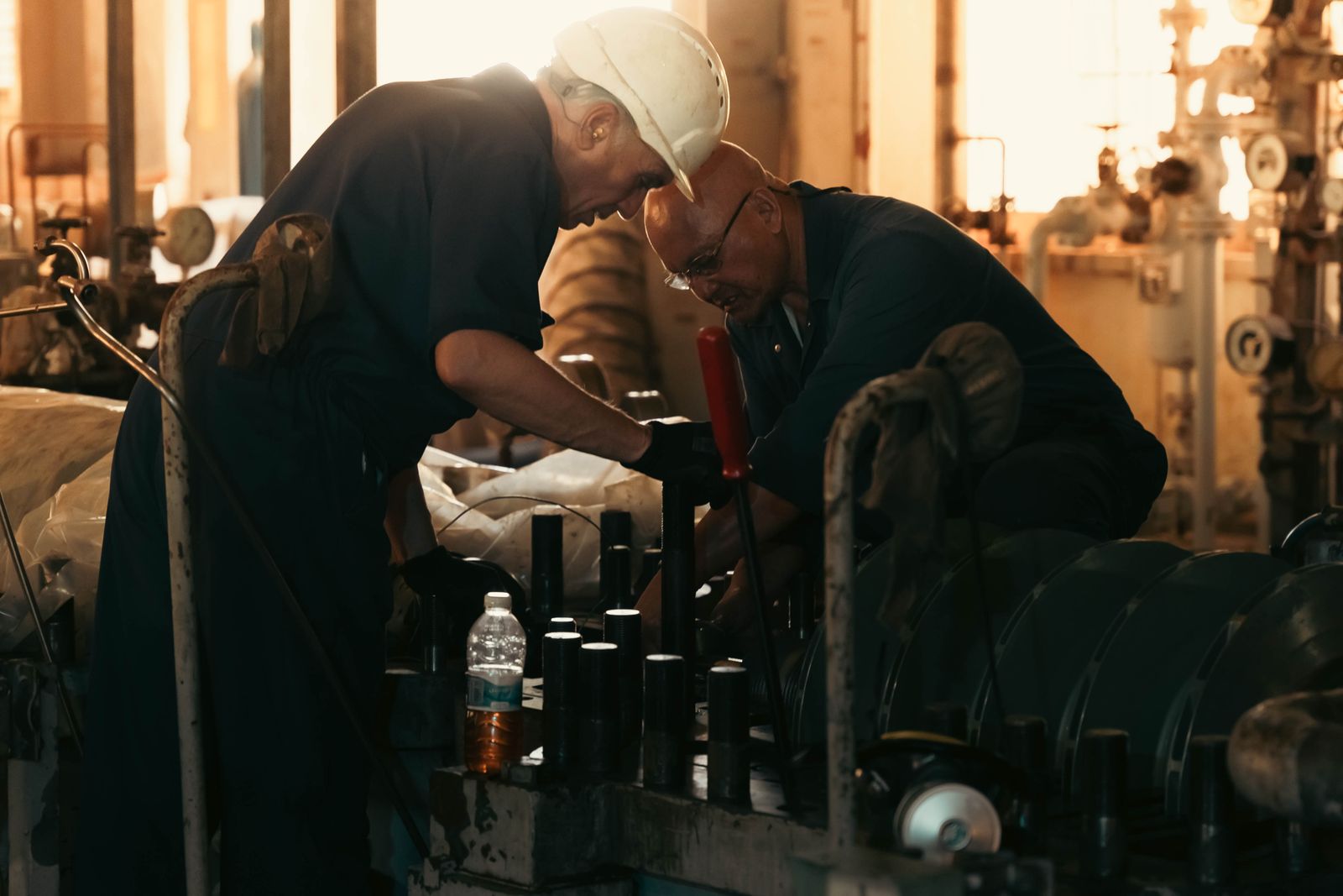 Engineers inspecting machinery on the plant floor